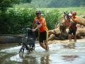 Larry Preble pushes his Lightning recumbent across the flooded low bridge over the Salt River. Ray Brown follows behind Larry but doesn't want his bike wet.